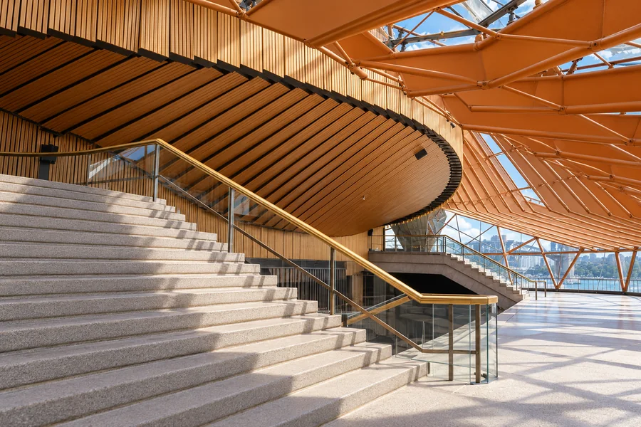 Wide interior stairs beneath timber cladding in the Sydney Opera House foyer